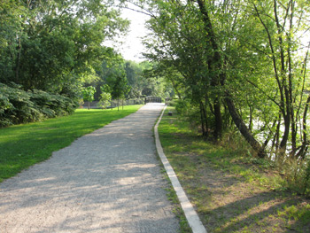 a gravel path leading to a bridge